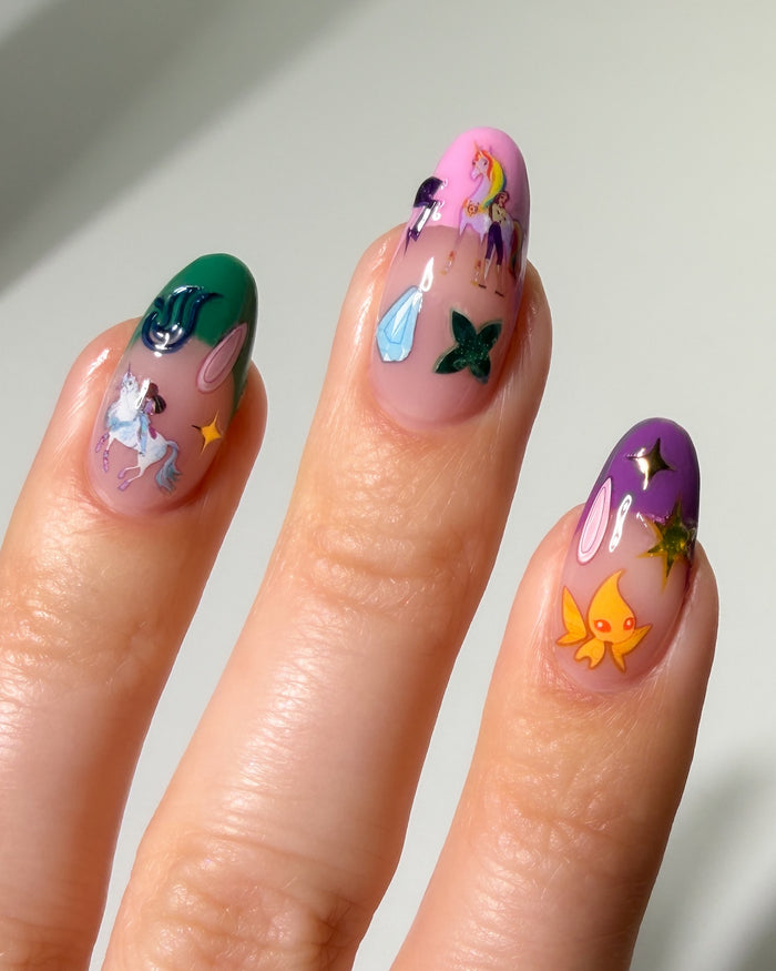 Nails with colorful nail art stickers on a neutral background