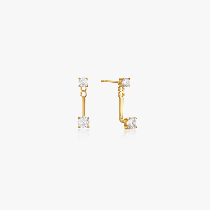 Double Gem Huggie Earrings feature gold-tone ear jackets with two clear gemstones, set on an 18K PVD gold-plated stainless steel bar, safe for sensitive skin.