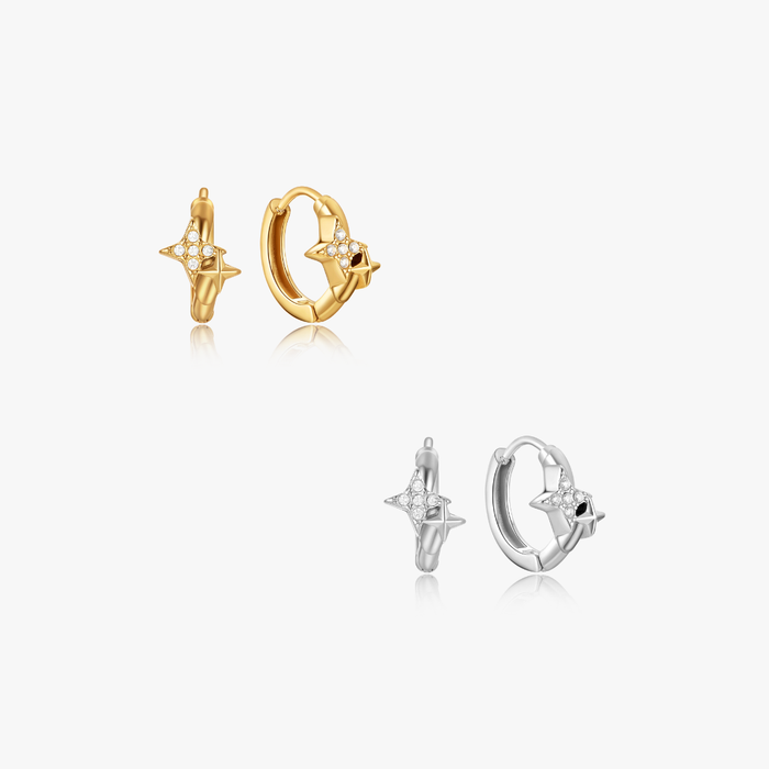 Estelle Double Star Mini Hoops featuring two pairs of small huggie earrings, each with a crystal-studded star charm, in gold and silver finishes.
