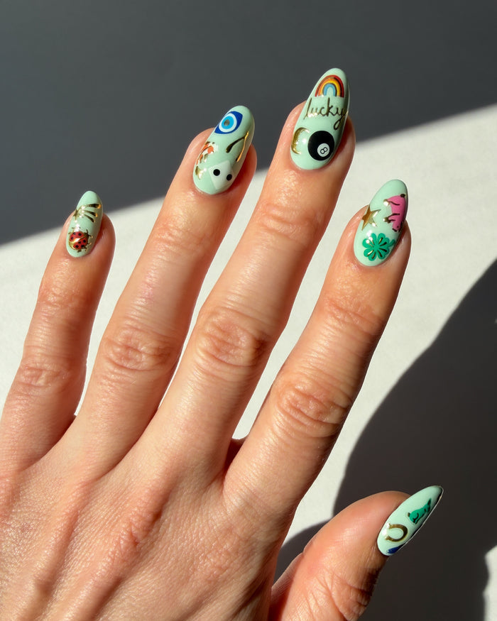 Good Fortune nail art stickers on minty nails