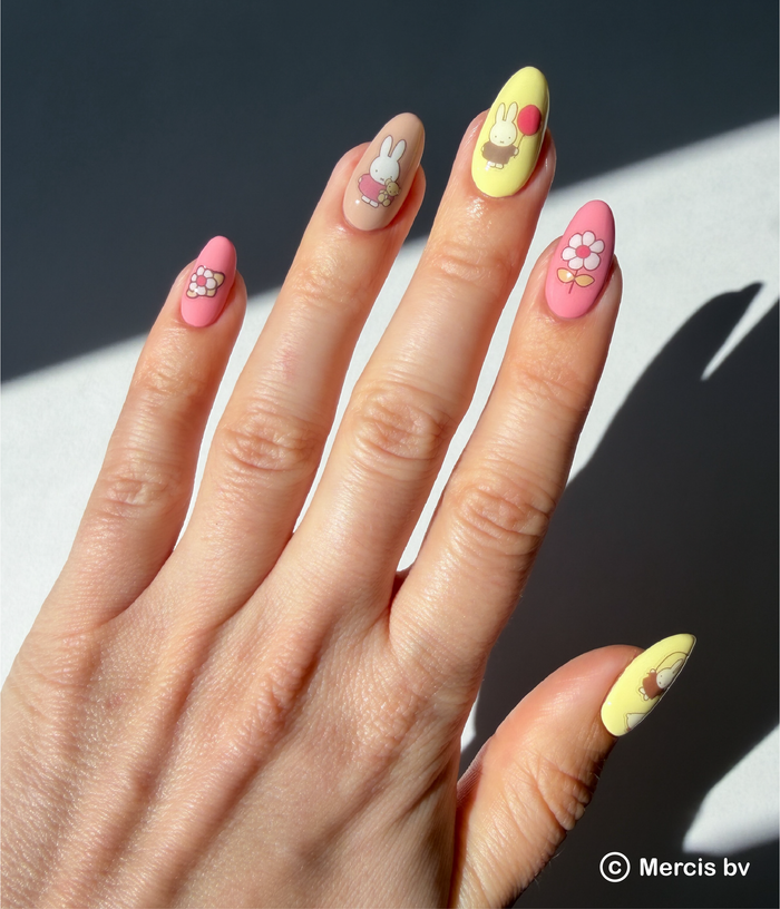 Hand with colorful nail art on a dark background