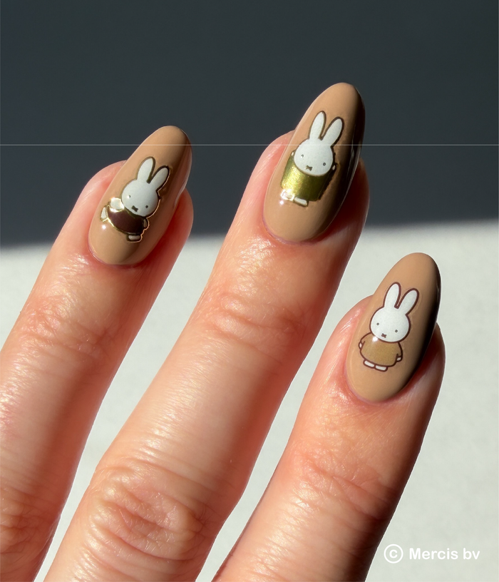 Nails with Miffy designs on a neutral background