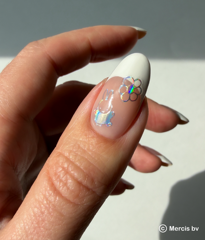 Hand with a french tip and holo nail art stickers