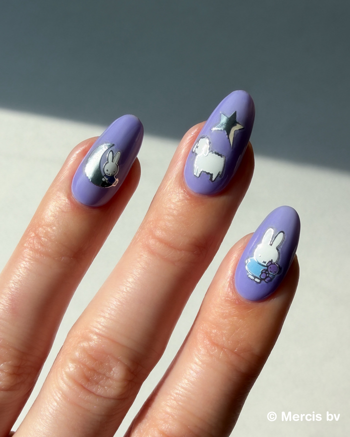 Nails with Miffy stickers on a neutral background
