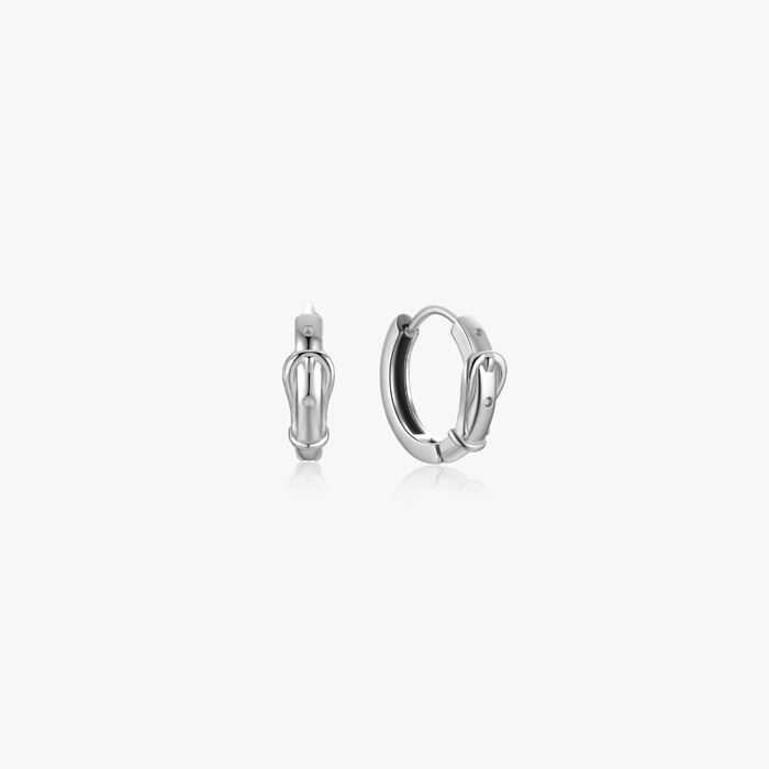 Mini Belt Hoops: small silver stainless steel hoop earrings with buckle detail, clear stone, and hinged clasp, sold in pairs, safe for sensitive skin.