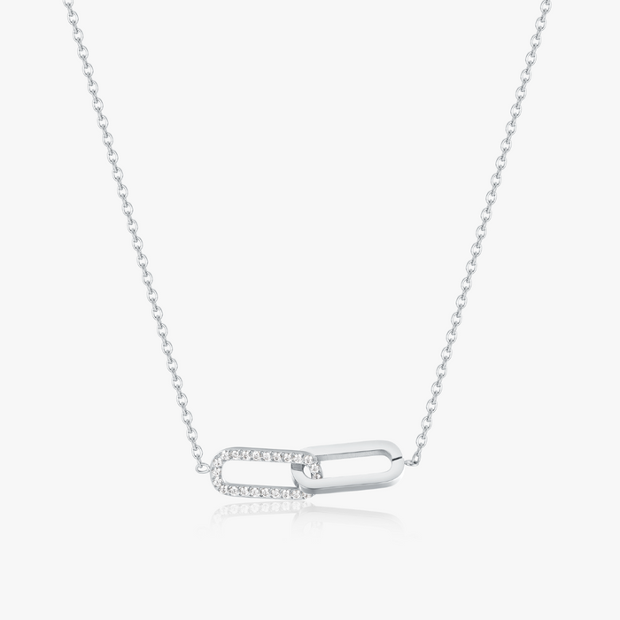 Pave Intertwined Links Necklace: A minimalist silver chain with two interlocking ovals, one plain and one adorned with sparkling stones.
