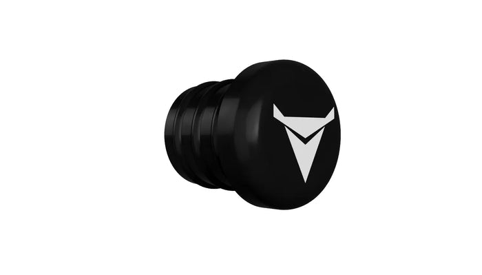The image shows a black cylindrical object with a slightly wider, rounded end displaying a white triangular logo. The body has several horizontal grooves, and the object resembles the Decibullz REPLACEMENT Single Back Plug set against a plain white background.