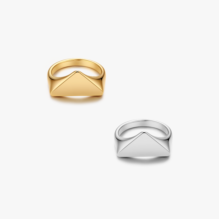 Sable Triangle Signet Ring featuring a geometric envelope-flap motif, available in yellow-gold and white-metal finishes, with polished stainless steel bands.