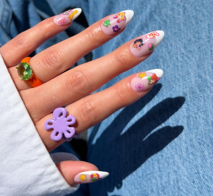 Nail with colorful stickers on a blue denim background