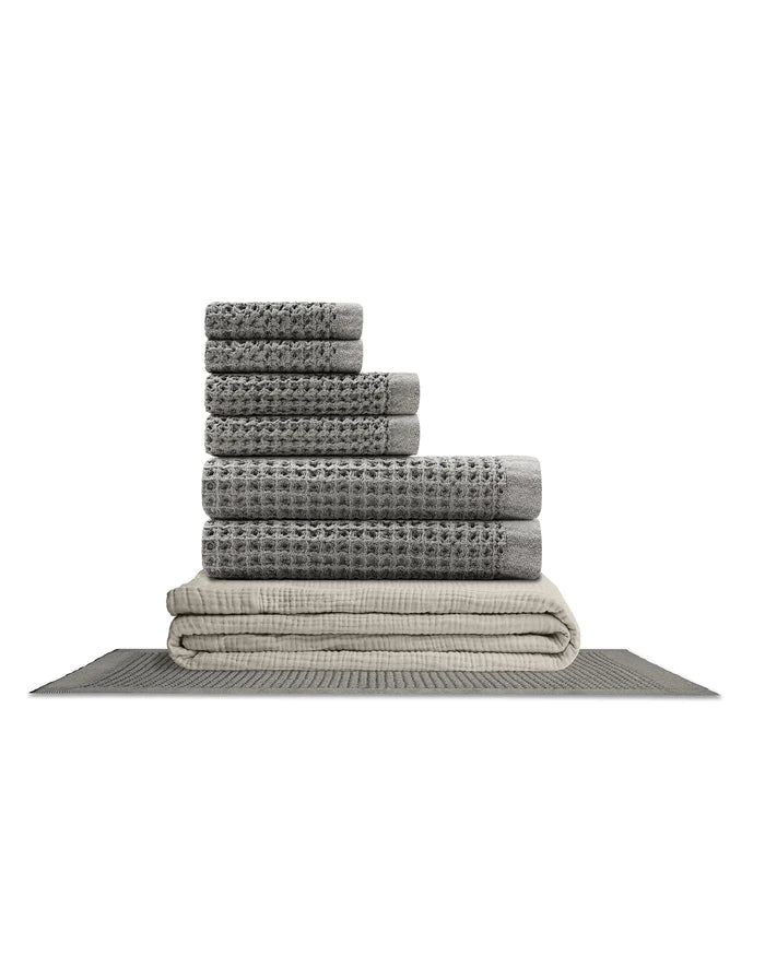 Supima waffle complete bathroom bundle featuring stacked towels and bath mat in gray tones.