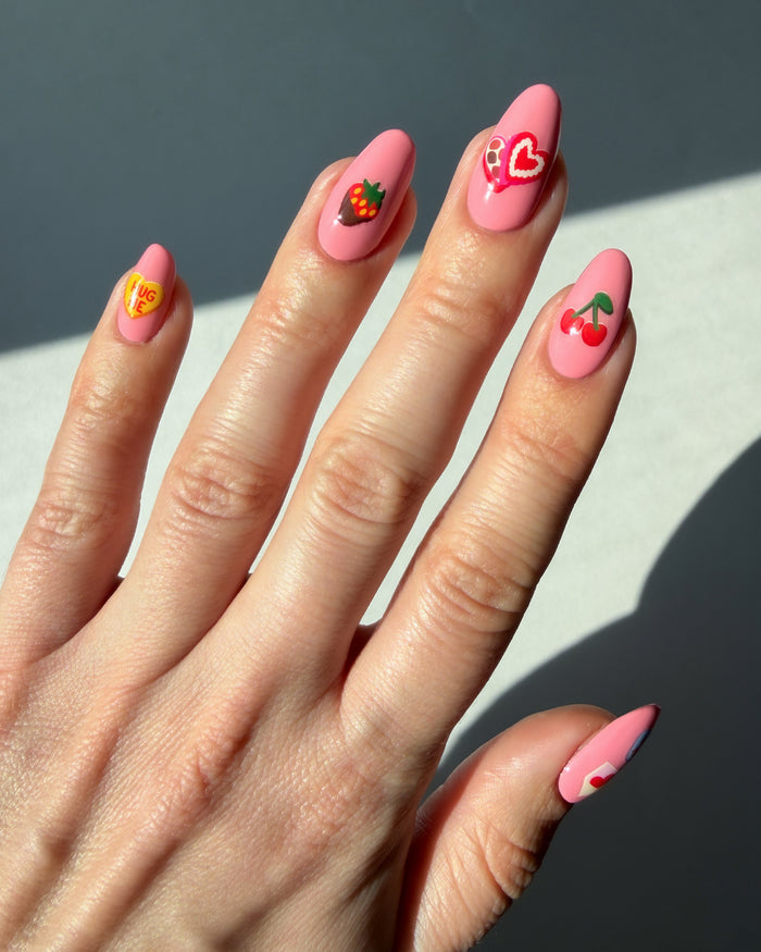 XOXO stickers on pink nails